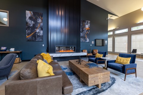 a living room with couches and chairs and a fireplace